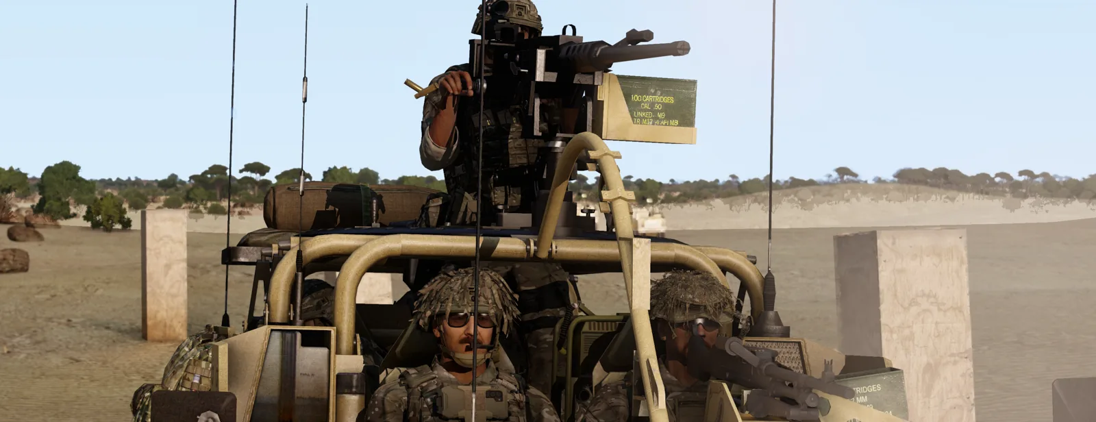 A .50 cal gunner and dismounts atop a Foxhound during a desert patrol.