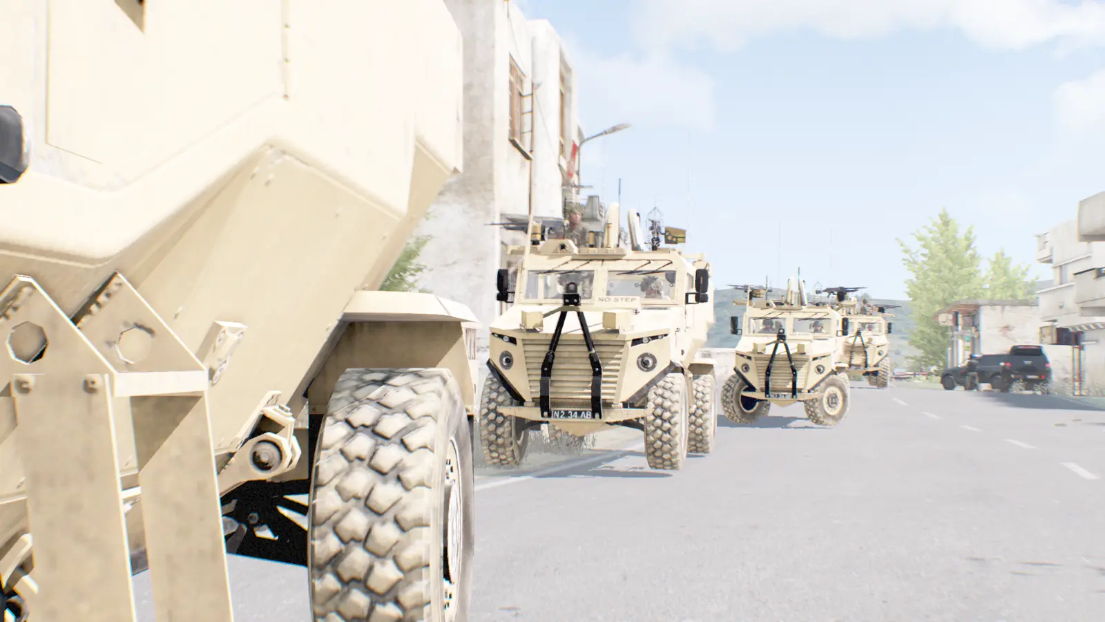 Foxhound convoy moving through a built-up area