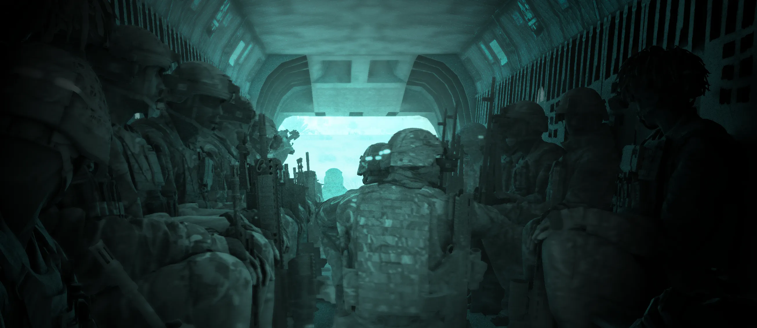 Troops seated in the back of a Chinook in flight.