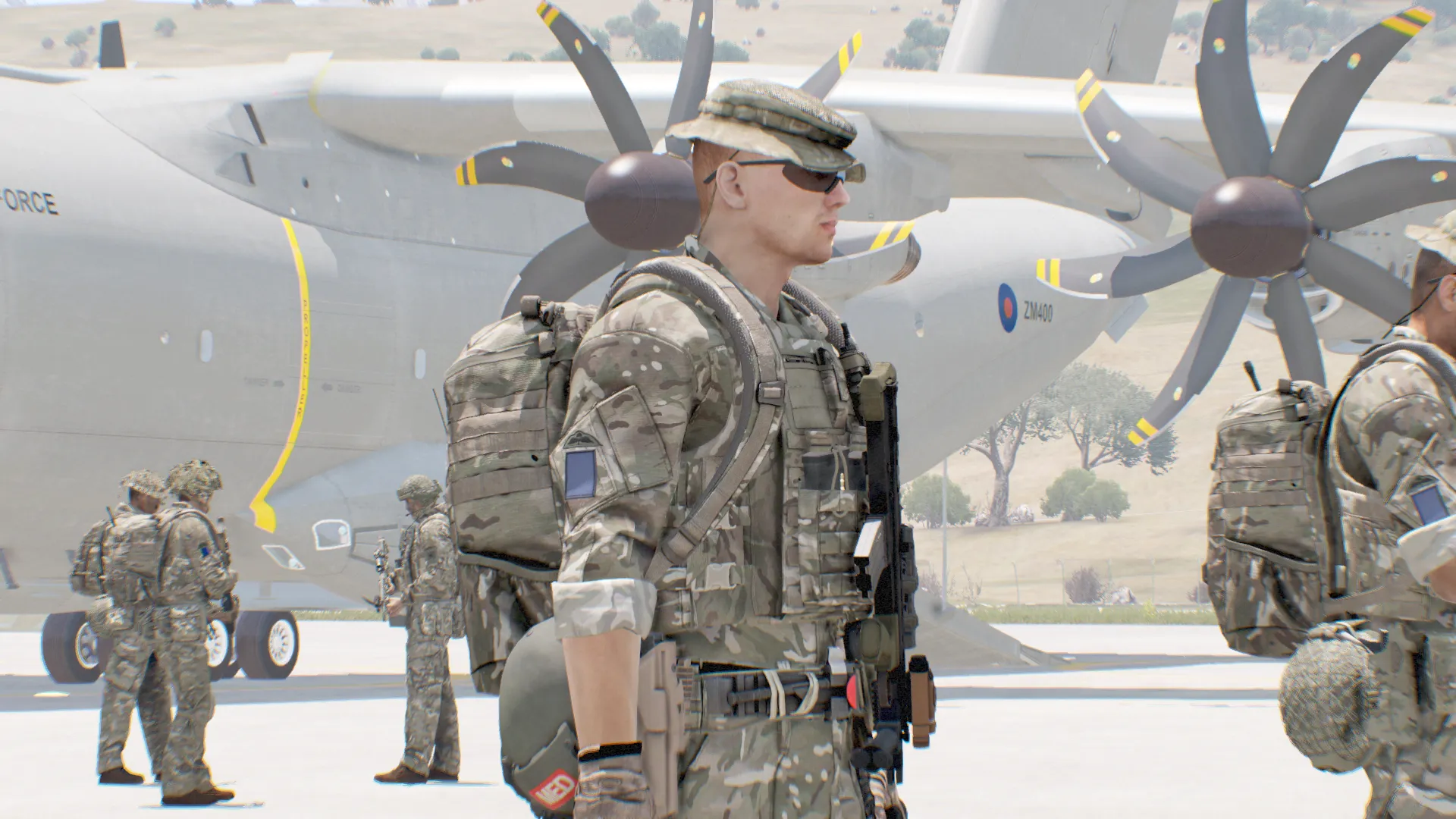 A soldier in a boonie hat on patrol.