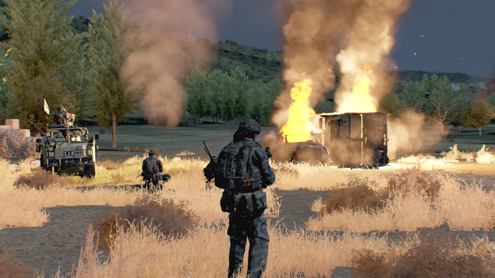 A vehicle convoy moving along a rural road.